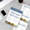 A restaurant opening and closing checklist document laid out on a wooden surface with a laptop, smartphone, and a coffee cup nearby. 